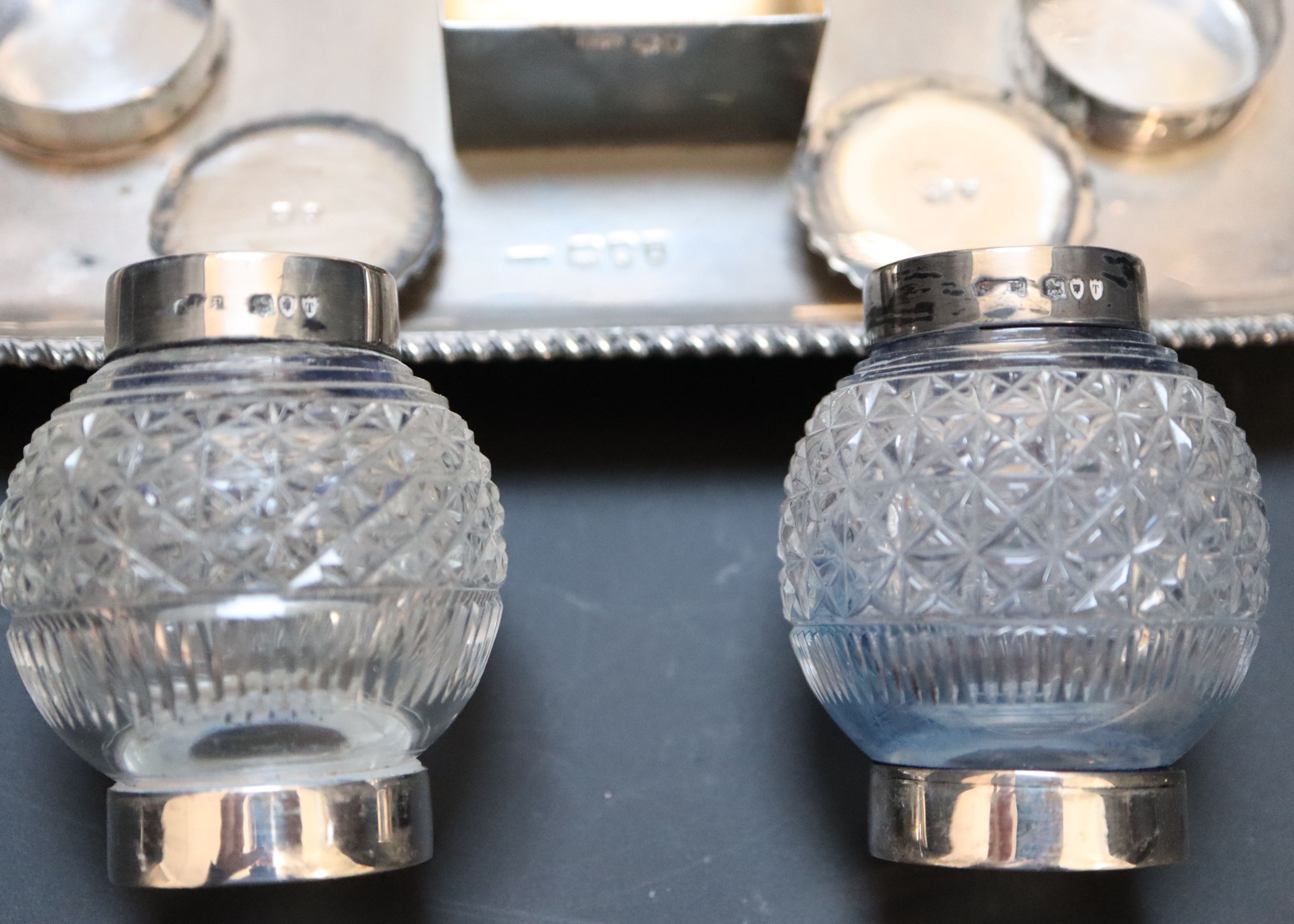 A late Victorian silver ovoid inkstand with two cut glass wells and central lidded compartment,